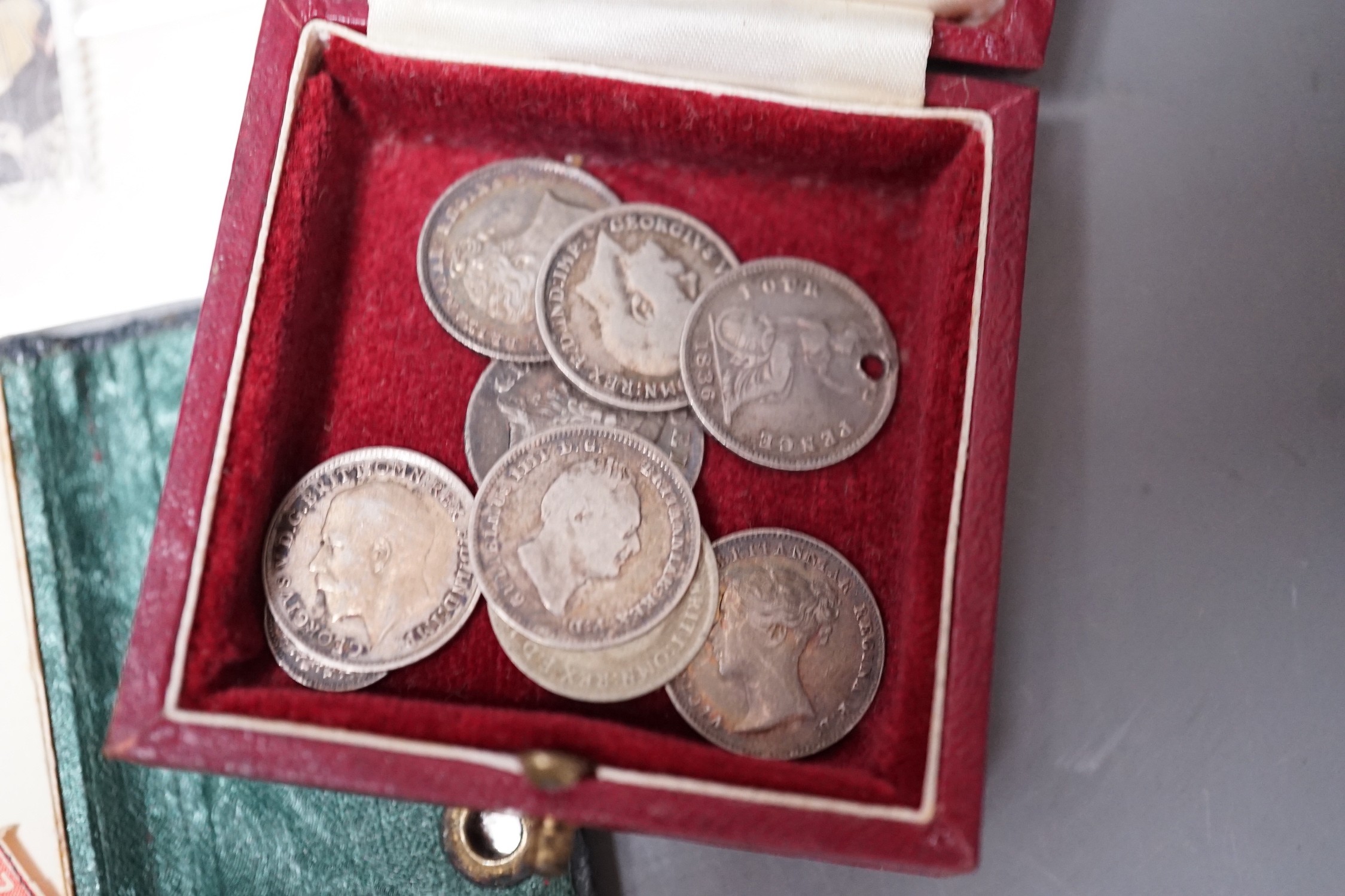 Nine silver four, three and one pence coins George III, Victoria and George V and a small quantity of stamps.